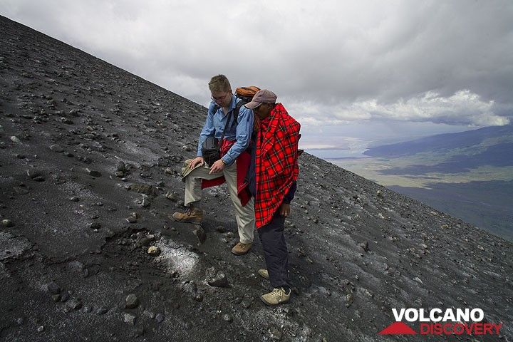 Philip und unser Maassai Führer Peter untersuchen einen der vielen frischen Einschlagskrater von Blöcken, die man hier auf dem Rücken zwischen den beiden Kratern findet. (Photo: Tom Pfeiffer)