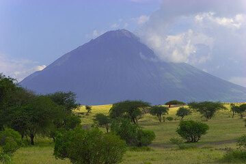 Ol Doinyo Lengai stratovolcano seen from the savannah near Lake Natron. The tall hornito T49b in its active north crater can be seen clearly. (Photo: Tom Pfeiffer)