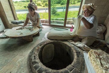 Preparation of lavash, the famous and very tasty flatbread of Armenia. Step 1: skillful hands shape the dough into a very thin flat shape. (Photo: Tom Pfeiffer)