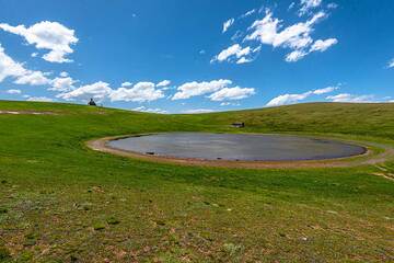 A small circular lake occupies the crater of Armaghan volcano. (Photo: Tom Pfeiffer)
