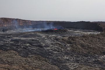 Ein erster Blick auf den Südkrater am 25. November 2010 von der westlichen Calderawand aus. Der Krater ist größtenteils mit Überläufen des Lavasees gefüllt, und der untere nördliche Rand des Kraters ist unter Überläufen verschwunden. (Photo: Tom Pfeiffer)