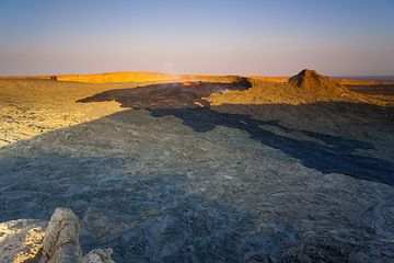 Evening view of Erta Ale's vast caldera with the lava lake that has filled up the south crater. The recent overflows are black on the floor of the caldera. (Photo: Tom Pfeiffer)