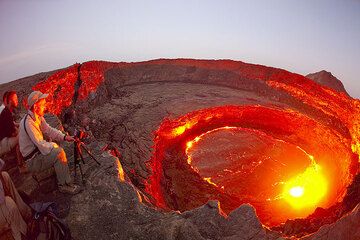 Claude, Olivier and Paul watch the activity of the lava lake. (Photo: Tom Pfeiffer)