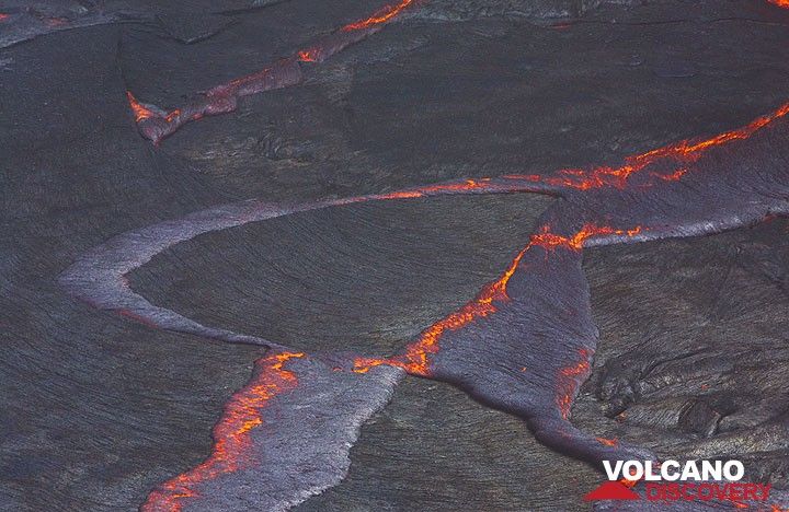 Floating pieces of barely solidified, dark lava crust covering Erta Ale's active lava lake form rifting and subduction patterns, illustrating Earth's Plate Tectonics in miniature. (Photo: Tom Pfeiffer)