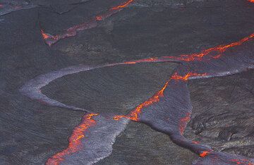 Floating pieces of barely solidified, dark lava crust covering Erta Ale's active lava lake form rifting and subduction patterns, illustrating Earth's Plate Tectonics in miniature. (Photo: Tom Pfeiffer)