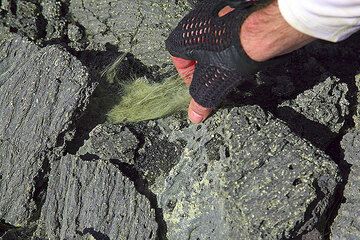El pelo de Pele, producido por el manantial del lago de lava y dispersado por el viento, se acumula en las grietas y rincones de las rocas del suelo. (Photo: Tom Pfeiffer)