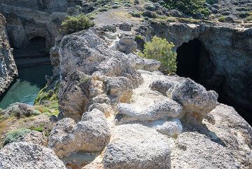 Sea caves at Papafrankos. Large pumice clasts form "pillows" on the eroded surface. (Photo: Tom Pfeiffer)
