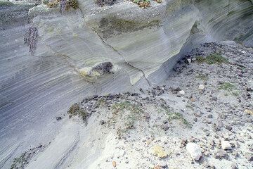 Faulted finely layered volcanic ash sediments containing a scoria bomb (Photo: Tom Pfeiffer)