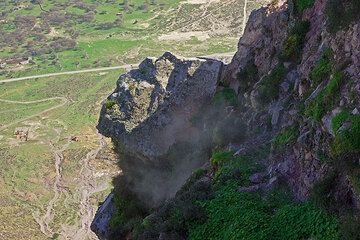 Hot steam escaping from a hydrothermal area on the cliff. (c)