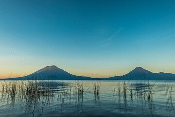 Morning view from the shore of Lake Atitlán with Atitlán/Toliman and San Pedro volcanoes on the opposite side. (Photo: Tom Pfeiffer)