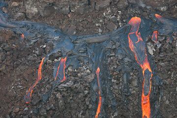 Two of the active vents (upper right) and several lava flows covering the older wall of the pit crater. (c)