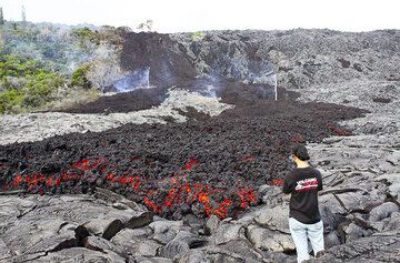 Philip stands by the leading edge of an 'a'a lava flow at the base of Pulama Pali, being fed from the Peace Day Fissure on Pu'u 'O'o vent on K?lauea volcano on December 4, 2011. (Photo: Philip Ong)