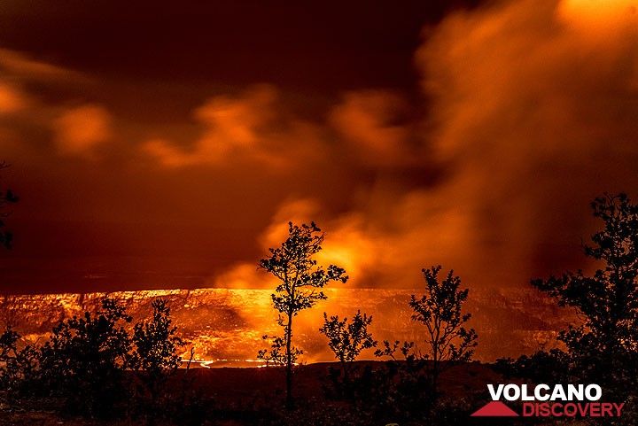 Small ohia trees form silhouettes against the red glow from the lava lake. (Photo: Tom Pfeiffer)