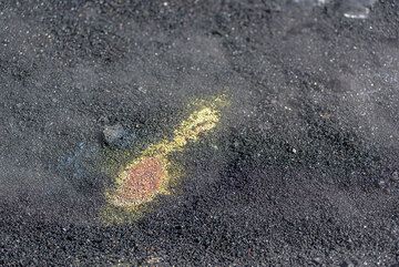 Yellow patch of sulfur and minerals on the fresh, still hot black sand on the bench. (Photo: Tom Pfeiffer)