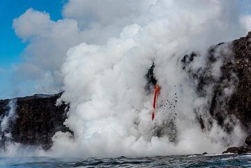 Most of the time, the lava hose is hidden in thick steam, but occasionally, it comes into sight. (Photo: Tom Pfeiffer)