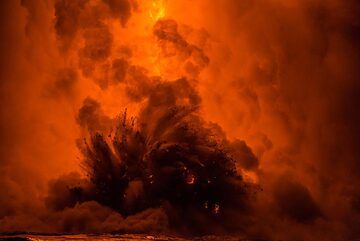 The lava hose can be barely seen behind the steam and explosion. (Photo: Tom Pfeiffer)