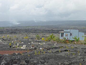 Day 2: Some new settlements atop the Pu´u O´o lava flows that covered a vast area since the start of the eruption in 1983. In the background, volcanic gasses are rising up above the largely underground path of the current lava flows to the ocean. (Photo: Ingrid Smet)