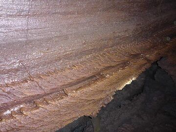 The walls in some parts of the lava cave show this interesting texture that was formed during different phases of lava flowing through the tunnel at a range of speeds and levels (Photo: Ingrid Smet)