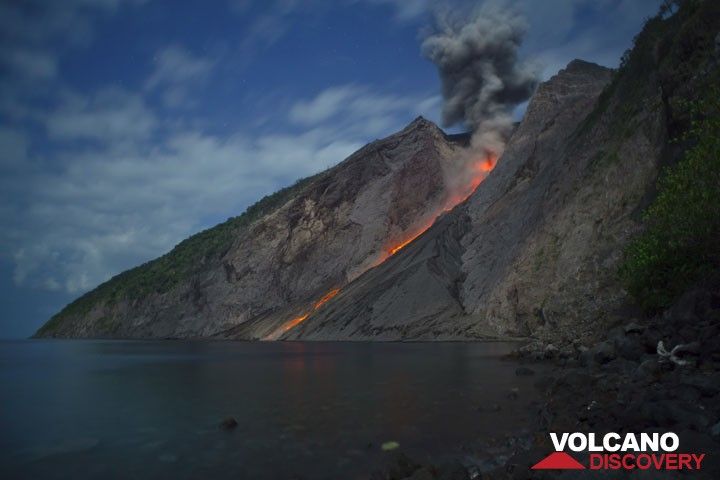 Strombolian explosion at night in moonlight with glowing lava blocks rolling down to the sea. (Photo: Tom Pfeiffer)