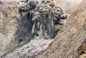 Moderately strong explosion with large bombs and blocks ejected, leaving ash trails in the air. (Photo: Tom Pfeiffer)