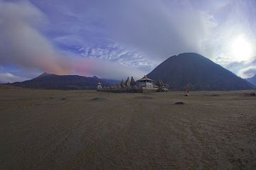 Bromo and the Hindu temple at its feet in a moonlit night. Jorge has his camera set up for the next eruption. (Photo: Tom Pfeiffer)