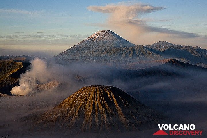 Volcanic trio: Batok cinder cone (foreground), smoking Bromo, and majestic Semeru with an umbrella cloud. 
This view of East Java's Tengger caldera (Indonesia) is one of the country's most famous viewpoints, visited every day by hundreds of tourists. (Photo: Tom Pfeiffer)