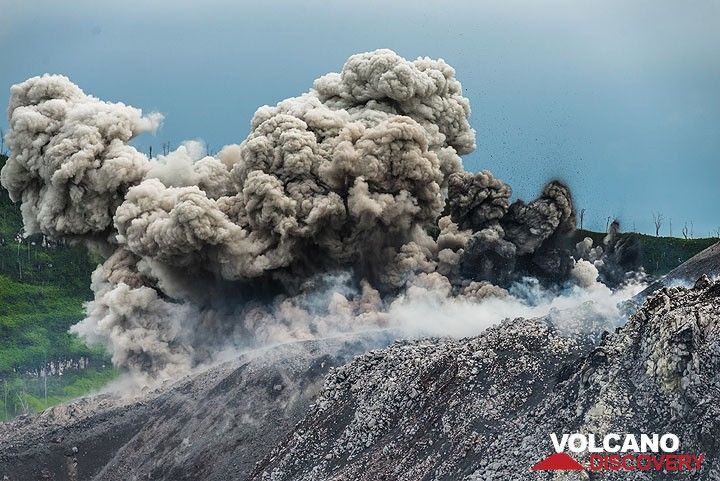Small jets of brown and black ash, along with many small bombs are ejected during an eruption from multiple vents at the eastern base of the cone. The dark (relatively cool) finger-shaped ash jets to the right along with the white steam plumes suggest phreatomagmatic activity (i.e. interaction of water with magma). (Photo: Tom Pfeiffer)