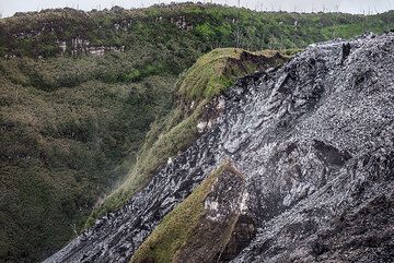 The present-day lava dome has filled and overspilled an inner crater (remnant of an older dome), small parts of which are still visible as vegetated remnants between the younger flows. (Photo: Tom Pfeiffer)