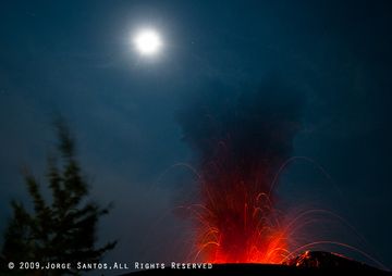 A tree silhouetted against the moon and an eruption from Anak Kraktau, seen from the trail leading up to the old crater rim. (Photo: Jorge Santos)