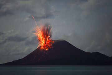 Initial stage of a powerful and fast explosion; a lightning is flashing in the beginning ash cloud. (24 Nov) (Photo: Tom Pfeiffer)