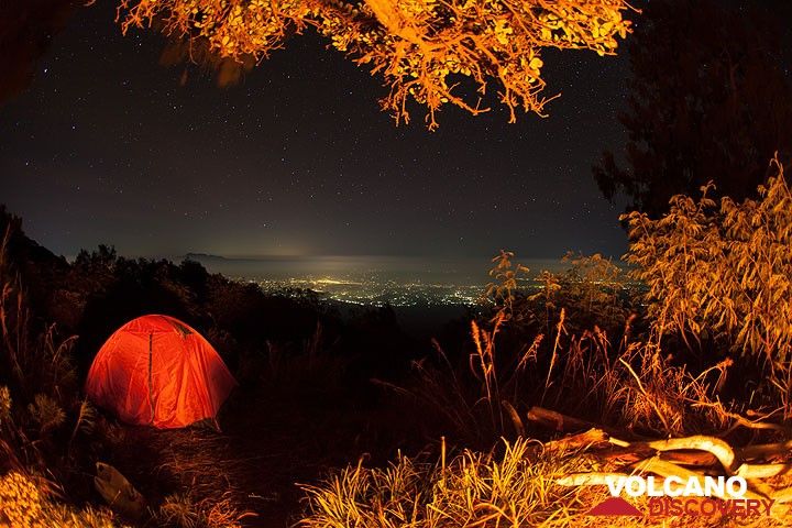 View from the basecamp at night, at 2750 m elevation near the end of the vegetation, illuminated by a campfire. A spectacular view to the NW over densely populated Java with the silhouette of Argopuro volcano (in the left). (Photo: Tom Pfeiffer)
