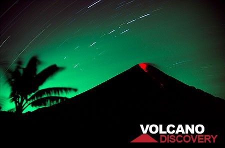 Erupting Semeru volcano at night (March 2004) - a small explosion expels incandescent bombs that roll down its southern flank. (Photo: Tom Pfeiffer)