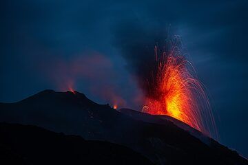 Glow and weak spattering from the eastern and central vents while an ash-rich eruption occurs from the western vent. (Photo: Tom Pfeiffer)