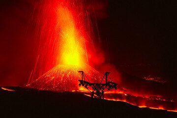 Eruption from the new crater and silhouette of an old cable car. (c)