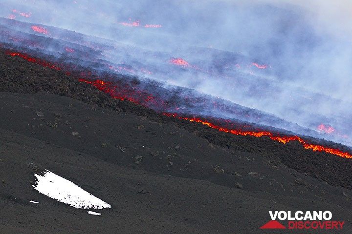 A patch of snow from the previous cold night and the edge of the lava flow from the eruption. (Photo: Tom Pfeiffer)