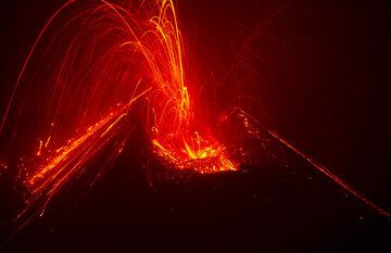 Strombolian explosion at night from the new cone inside Bocca Nuova crater of Etna volcano in Aug 2012 (Photo: Tom Pfeiffer)