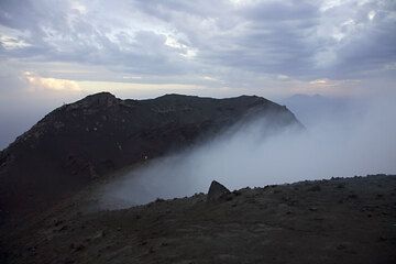 Strong scirocco wind creates turbulence in the crater, trapping the fumes in there. (c)