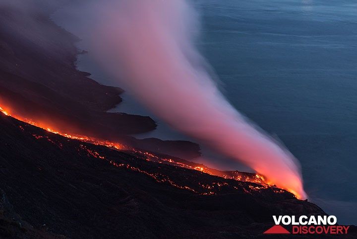 Lava flow illuminating the steam plume after night fall. (Photo: Tom Pfeiffer)