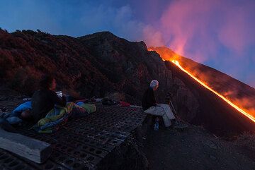 Martin taking pictures, while others just wake up to admire the lava flow in front of us again. (Photo: Tom Pfeiffer)