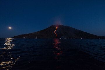 Full moon rising and Stromboli island with its lava flow, the first since 2007 to reach the sea. (Photo: Tom Pfeiffer)