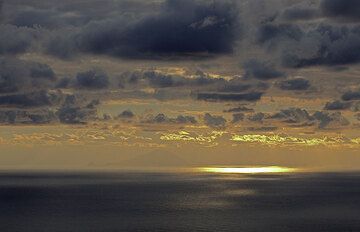 Sunset from Stromboli, in the distance, Filicudi Island is seen. (Photo: Tom Pfeiffer)