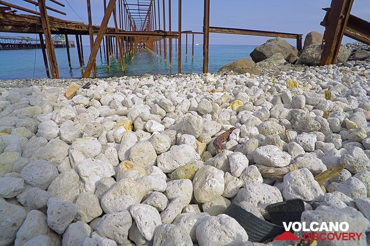 Pumice pebbles and old rusted structures of piers at the pumice quarry on Lipari  (Photo: Tom Pfeiffer)