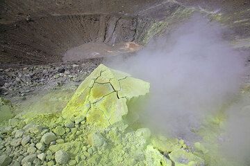 Sulphur crusted breadcrust bomb on the rim of Fossa volcano's crater, Vulcano Island (Photo: Tom Pfeiffer)