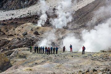 Very well organized group of Swiss hikers standing in front of a fumarole. (Photo: Tom Pfeiffer)