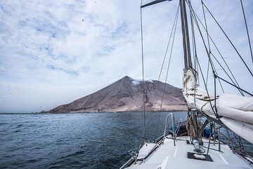 We are approaching the island volcano Raikoke which has erupted with a devastating large explosion on 22 June 2019, which left a lush green island now completely covered in ash. (Photo: Tom Pfeiffer)