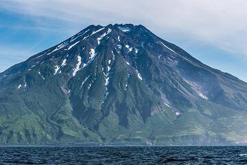 We approach the southern part of Paramushir, dominated by Fuss stratovolcano (1772 m) which forms a peninsula. (Photo: Tom Pfeiffer)