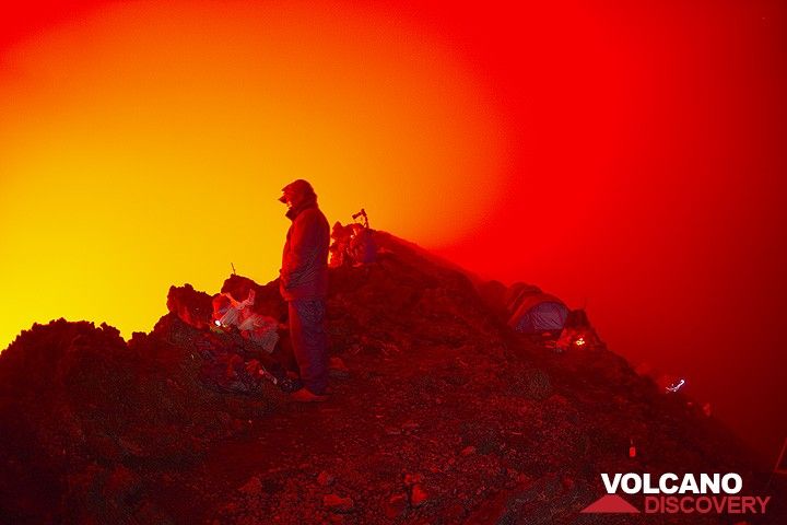 Watching the lava lake, the night is illuminated red by its glow. (Photo: Tom Pfeiffer)