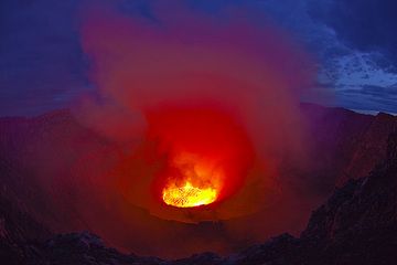 As morning approaches, the intense red and yellow light of the lava once again mixes with the blue of the sky, creating a unique spectacle. (Photo: Tom Pfeiffer)