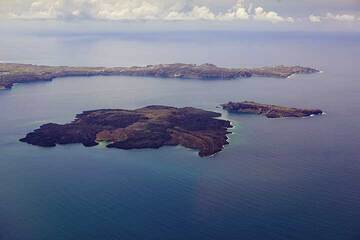 Îles volcaniques Nea Kameni (à gauche) et Palea Kameni au centre de la caldeira de Santorin vues du ciel. La péninsule d'Akrotiri en arrière-plan. Les sources hydrothermales sous-marines autour de Nea Kameni provoquent une décoloration de l'eau de mer autour de l'île, visible sur la photo. (Photo: Tom Pfeiffer)