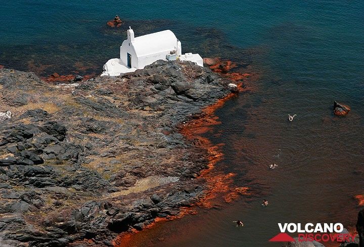 Chapelle Agios Nikolaos sur l'île Palea Kameni, l'une des deux îles volcaniques historiques au centre de la caldeira de Santorin (Grèce). La mer autour de l'île avec ses petites baies est une destination populaire pour les croisières en bateau : les nageurs profitent des eaux chaudes de la baie de fer rouge.
La tache orange des roches sur le rivage est le résultat d'un dépôt d'oxyde de fer provenant d'un système de ventilation hydrothermale actif sur les fonds marins peu profonds autour des îles Kameni. Il libère des eaux chauffées et riches en fer et dépose une couche de boue ferreuse sur le fond marin. (Photo: Tom Pfeiffer)